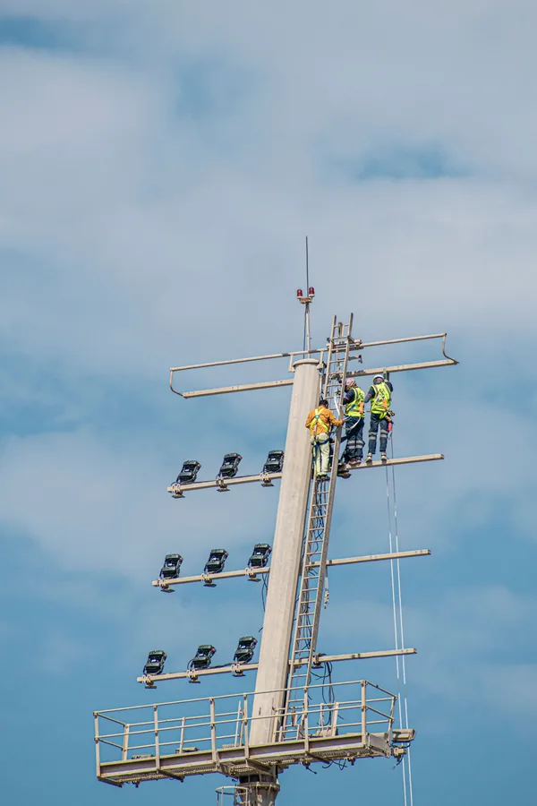 Technicians working on a telecommunications structure